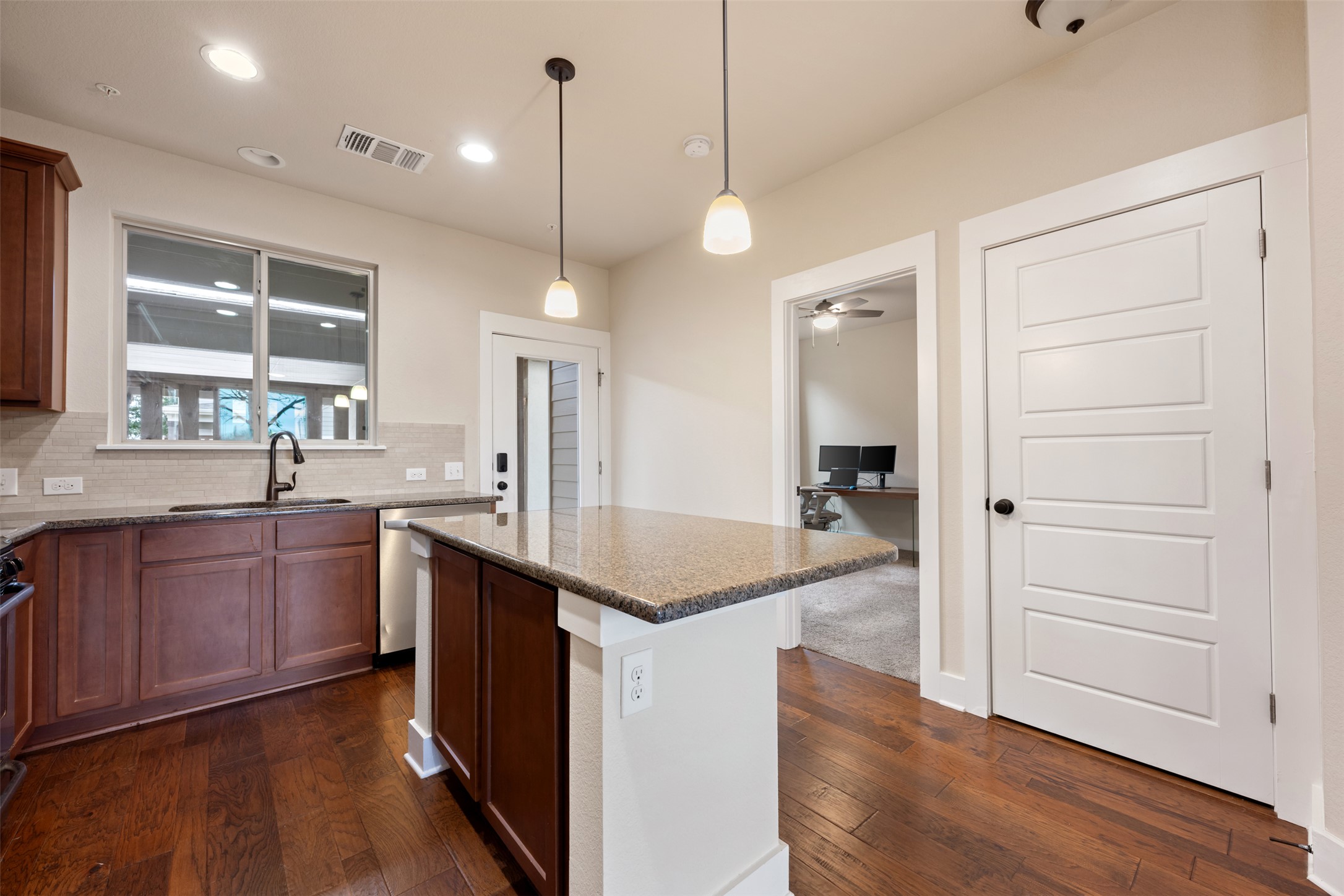 7615 Wolverine Street Austin, TX 78757 - Photo 15 of 40 a kitchen with a refrigerator a sink and dishwasher with wooden floor
