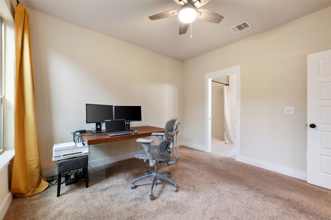 7615 Wolverine Street Austin, TX 78757 - Photo 18 of 40 a view of a workspace with furniture and a window