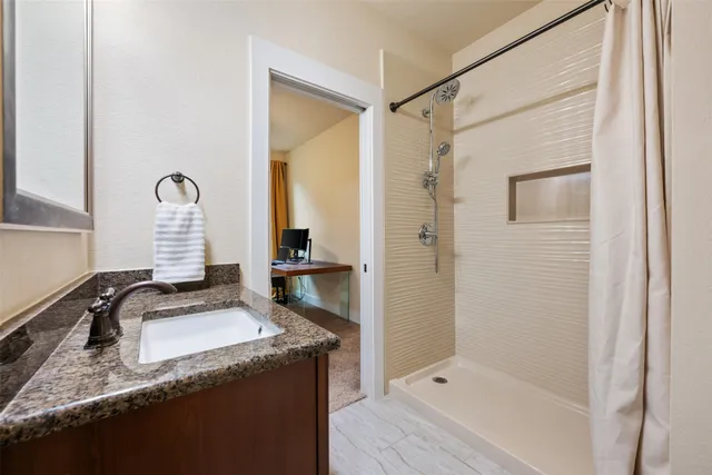 a bathroom with a sink and a shower