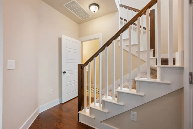 a view of entryway and hall with wooden floor