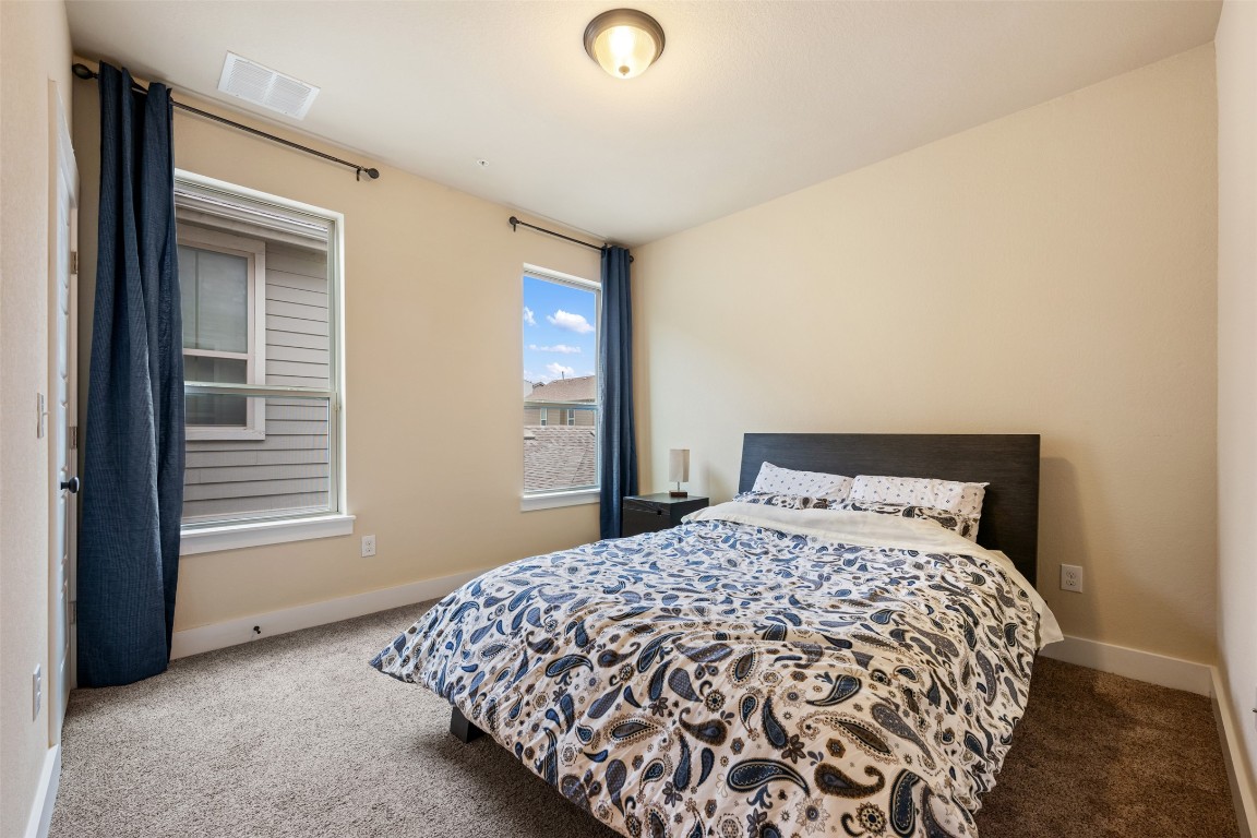 7615 Wolverine Street Austin, TX 78757 - Photo 31 of 40 a bedroom with a bed and a window