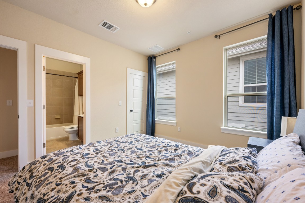7615 Wolverine Street Austin, TX 78757 - Photo 32 of 40 a bedroom with a bed and a dresser