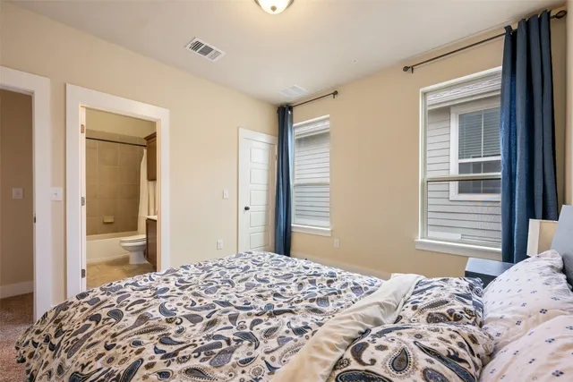 a bedroom with a bed and a dresser