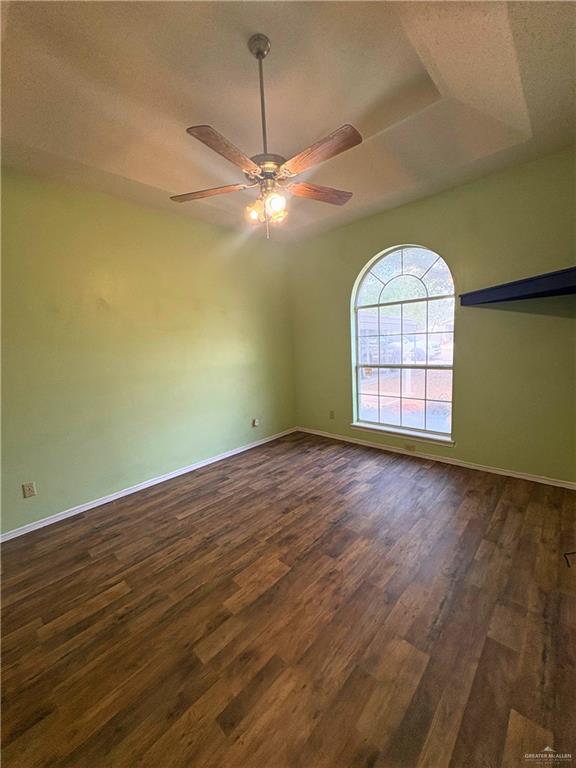 1614 Grovewood Road Mission, TX 78573 - Photo 18 of 25 an empty room with wooden floor chandelier and windows