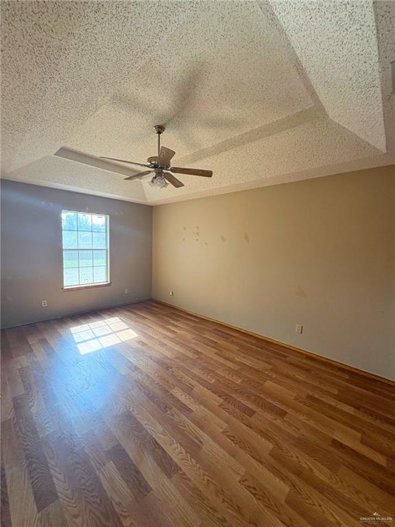 1614 Grovewood Road Mission, TX 78573 - Photo 19 of 25 an empty room with wooden floor fan and windows