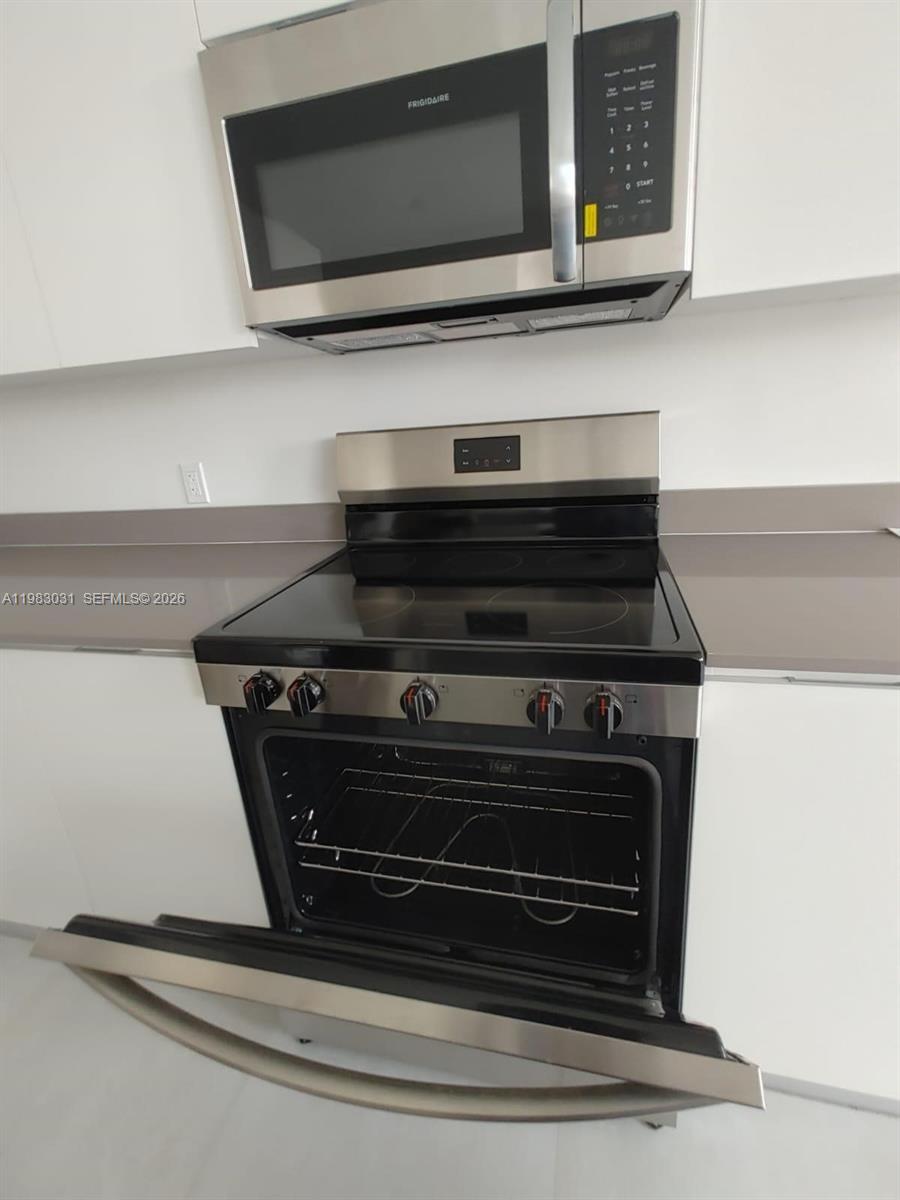 18983 Southwest 345th Terrace Homestead, FL 33034 - Photo 6 of 33 a stove top oven sitting inside of a kitchen