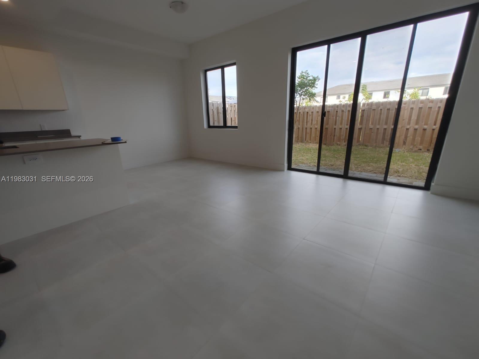 18983 Southwest 345th Terrace Homestead, FL 33034 - Photo 7 of 33 a view of an empty room with glass door