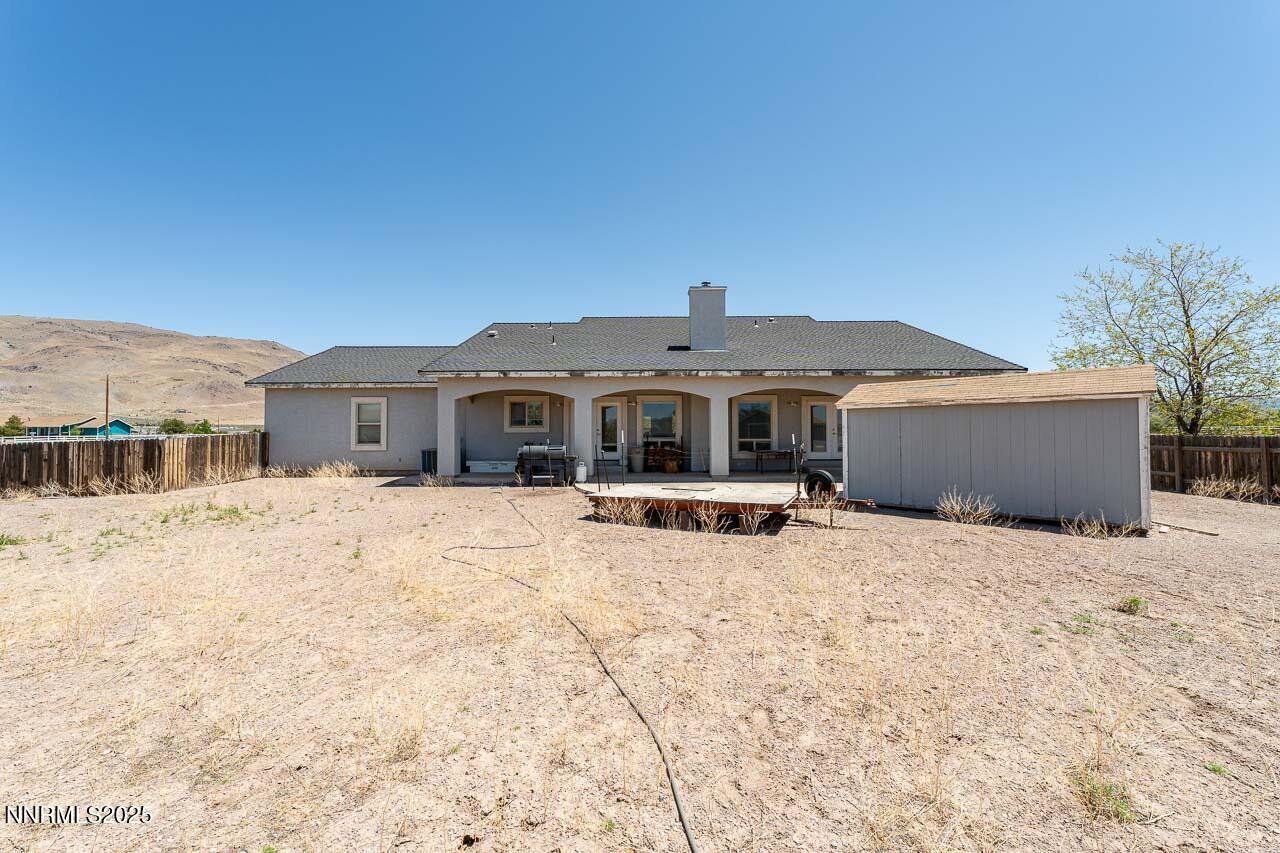 4945 Broken Spur Road Reno, NV 89510 - Photo 27 of 38 a front view of a house with a yard