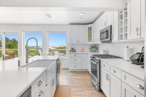a kitchen with white cabinets and white appliances