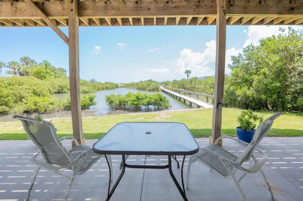 a view of a chairs and table in patio