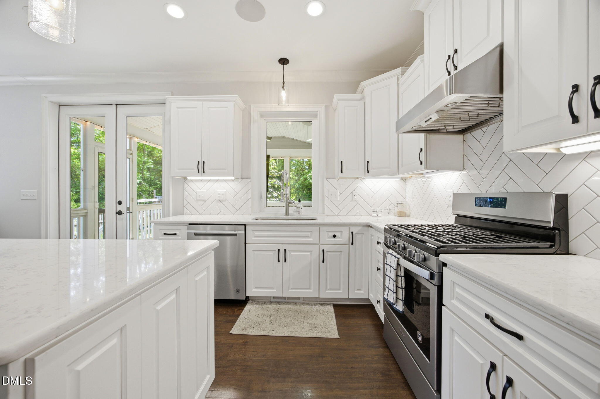 211 Long Street Fuquay-Varina, NC 27526 - Photo 13 of 38 a kitchen with granite countertop a sink stove and cabinets