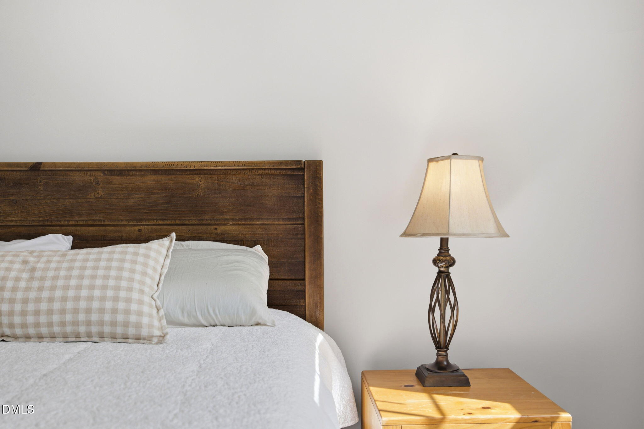 211 Long Street Fuquay-Varina, NC 27526 - Photo 16 of 38 a bedroom with a bed and a chandelier