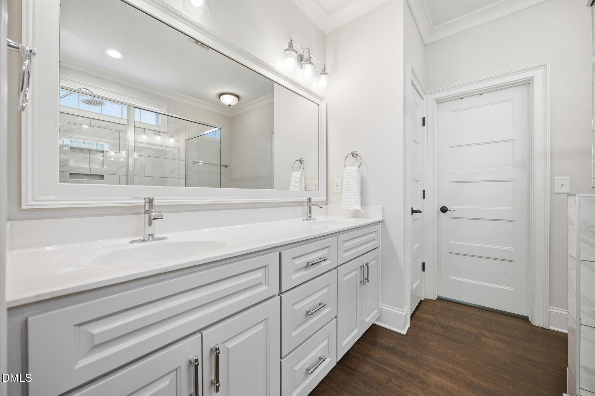 211 Long Street Fuquay-Varina, NC 27526 - Photo 19 of 38 a spacious bathroom with a double vanity sink a mirror and shower