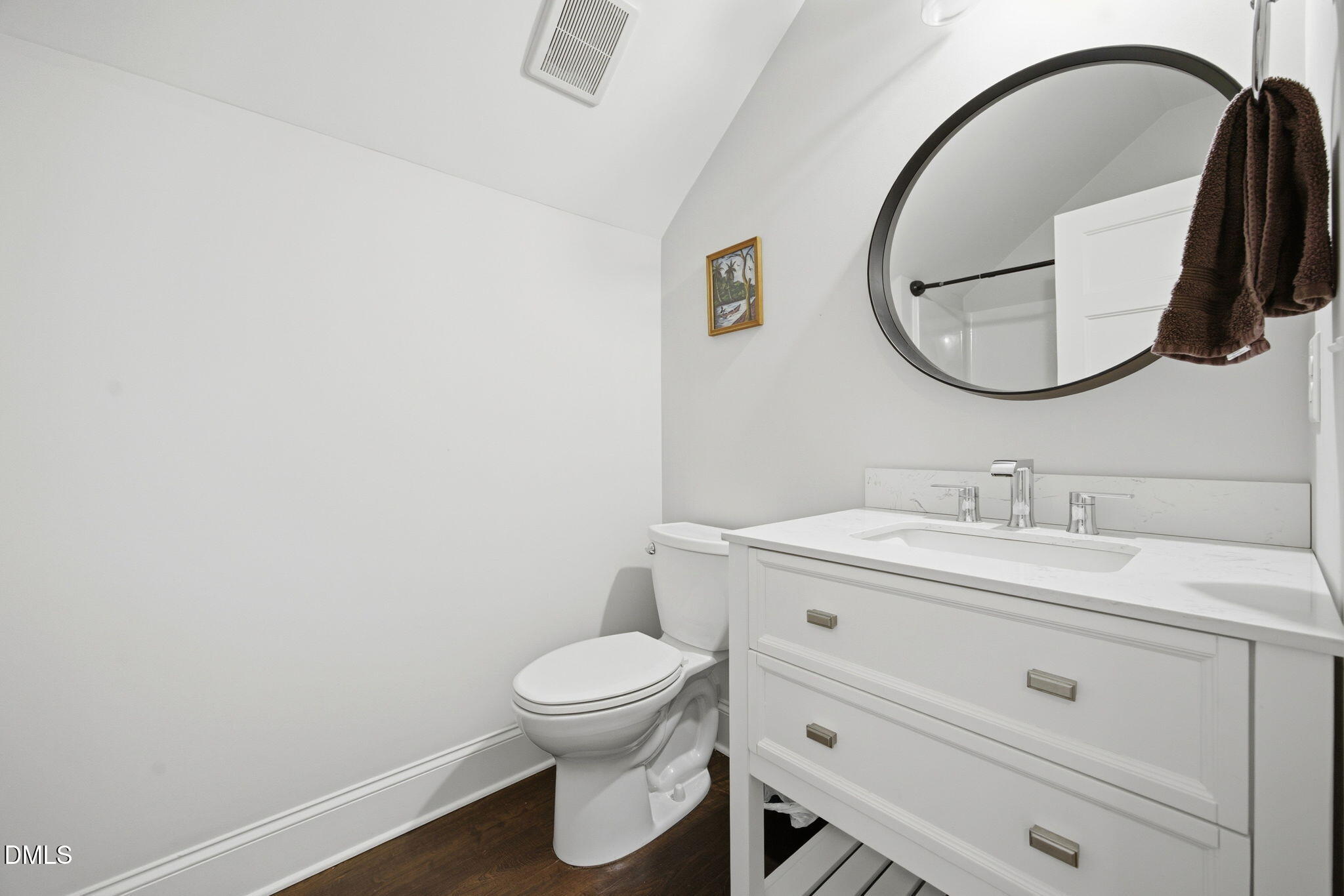 211 Long Street Fuquay-Varina, NC 27526 - Photo 25 of 38 a bathroom with a toilet sink vanity and mirror