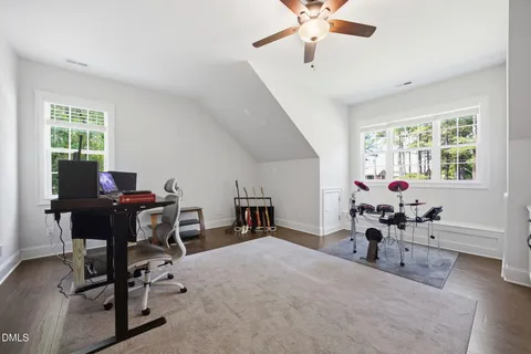 a workspace with chandelier fan and a window