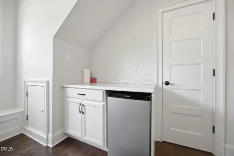 a kitchen with a refrigerator and cabinets