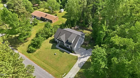 an aerial view of a house with a yard basket ball court and outdoor seating