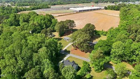 an aerial view of a house with a yard and lake view
