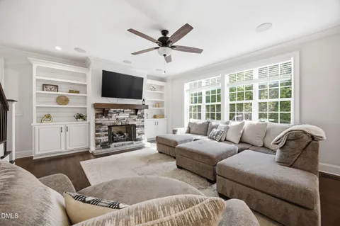 a living room with furniture a fireplace and a flat screen tv
