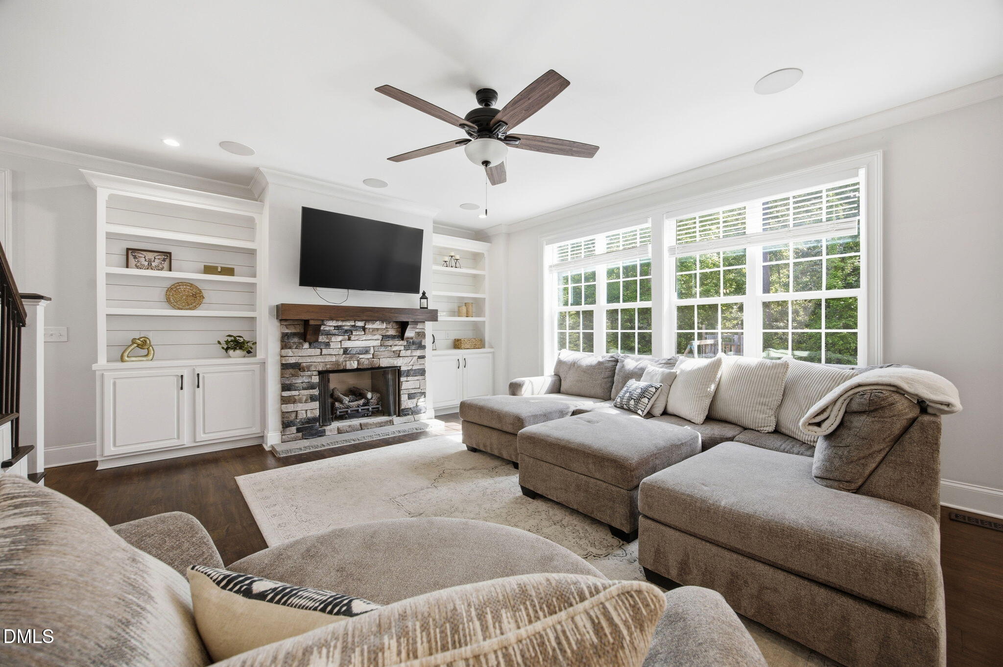 211 Long Street Fuquay-Varina, NC 27526 - Photo 7 of 38 a living room with furniture a fireplace and a flat screen tv