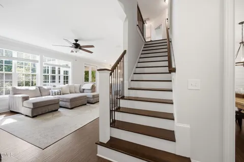 a living room with furniture and stairs