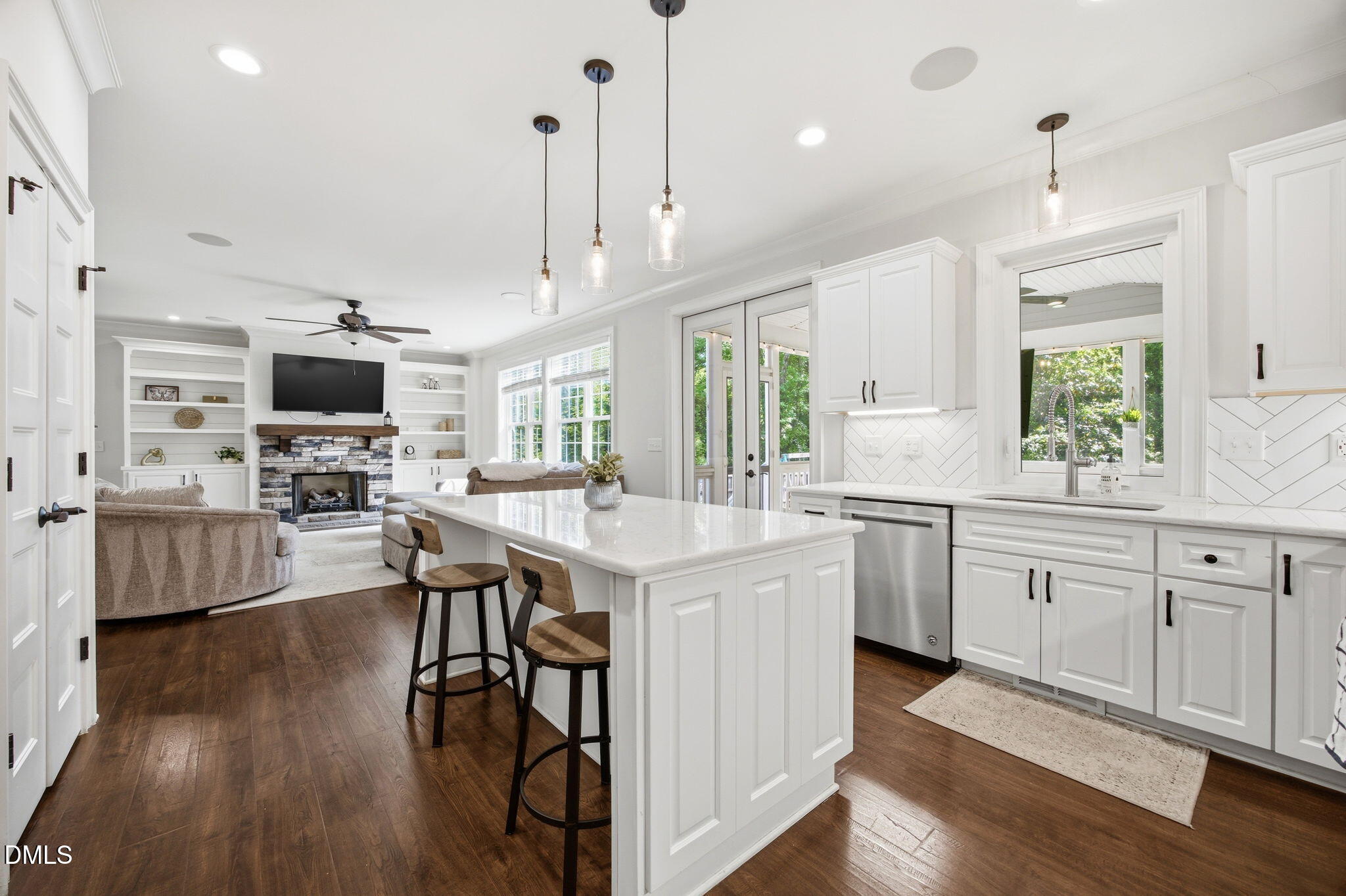 211 Long Street Fuquay-Varina, NC 27526 - Photo 10 of 38 a large kitchen with cabinets wooden floor and stainless steel appliances