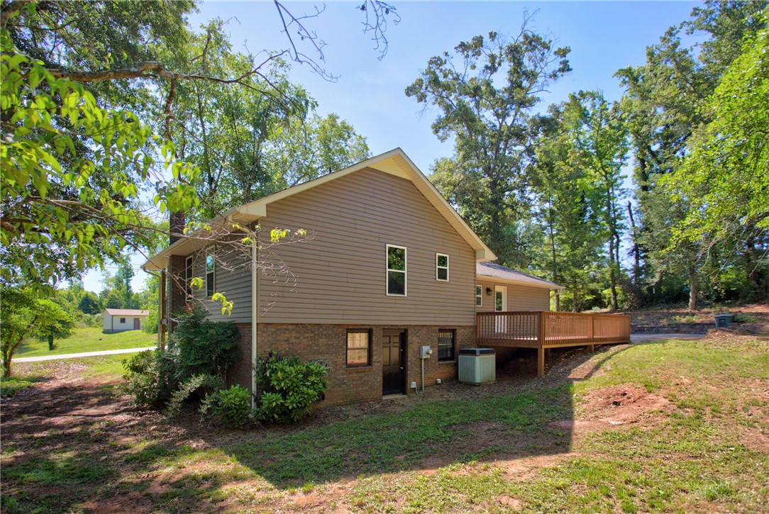 712 Beech Drive Seneca, SC 29678 - Photo 6 of 41 A spacious backyard with an elevated wood deck offers an ideal setting for outdoor enjoyment.