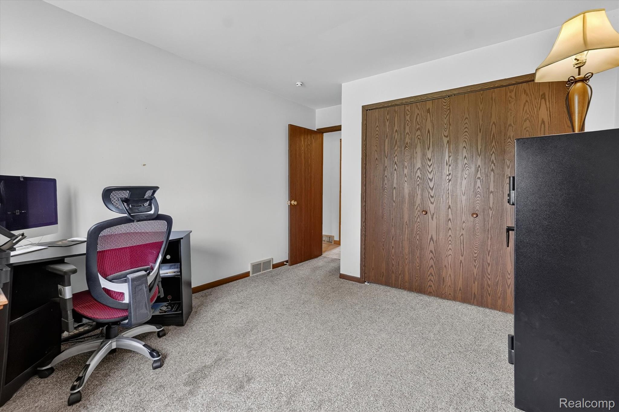 6895 Stow Road Fowlerville, MI 48836 - Photo 18 of 45 Wall-to-wall carpeting with solid wood bi-fold closet doors and a coordinating solid wood interior door