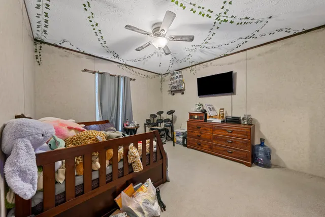 a bedroom with furniture and a flat screen tv