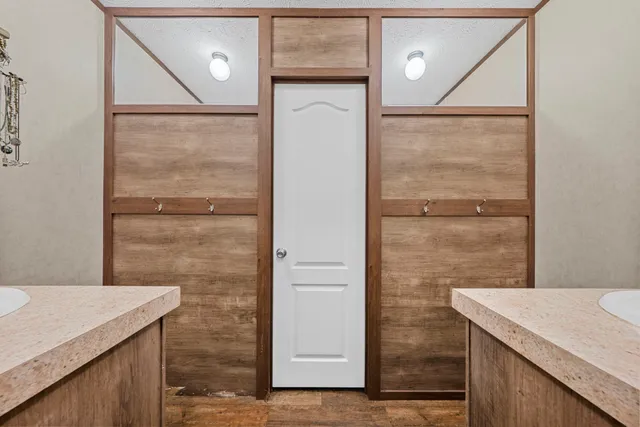 a bathroom with a granite countertop sink a mirror and shower