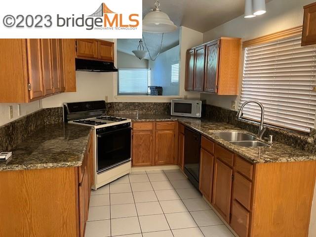 Oakley Oakley, CA 94561 - Photo 2 of 7 a kitchen with stainless steel appliances granite countertop a stove a sink and a microwave