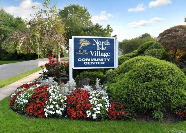 a view of sign board with yard and green space