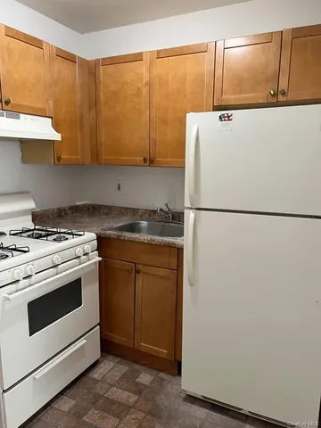 a white refrigerator freezer sitting inside of a kitchen