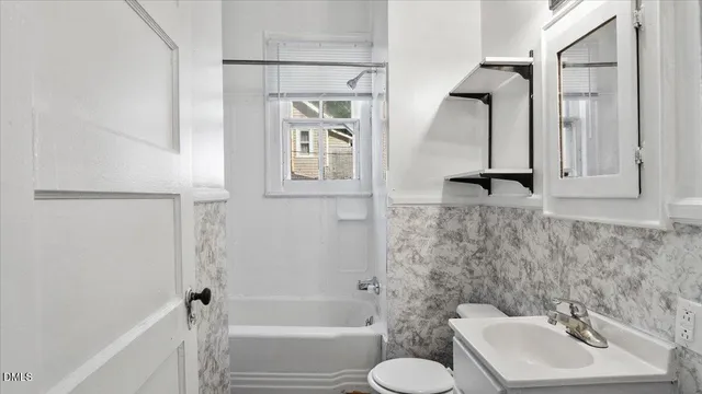 a view of a hallway with a wooden door