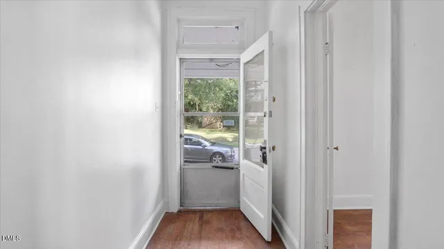 an empty room with a hardwood and a ceiling fan