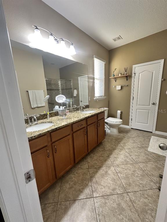 11248 Mollymawk Court New Port Richey, FL 34654 - Photo 13 of 21 a spacious bathroom with a granite countertop sink toilet and mirror