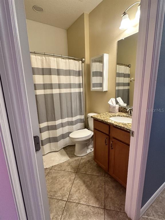 11248 Mollymawk Court New Port Richey, FL 34654 - Photo 5 of 21 a bathroom with a granite countertop sink a toilet a mirror and shower