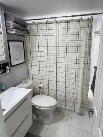 a bathroom with a toilet and shower