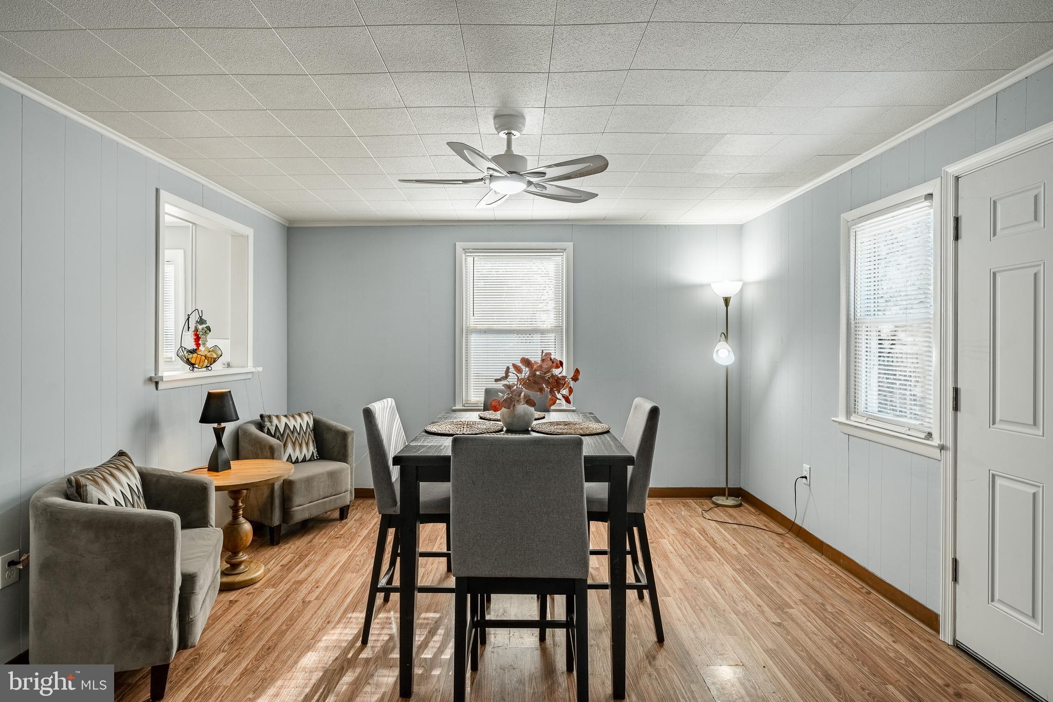 8 Garrett Road Wilmington, DE 19809 - Photo 12 of 37 a dining room with furniture a chandelier and wooden floor