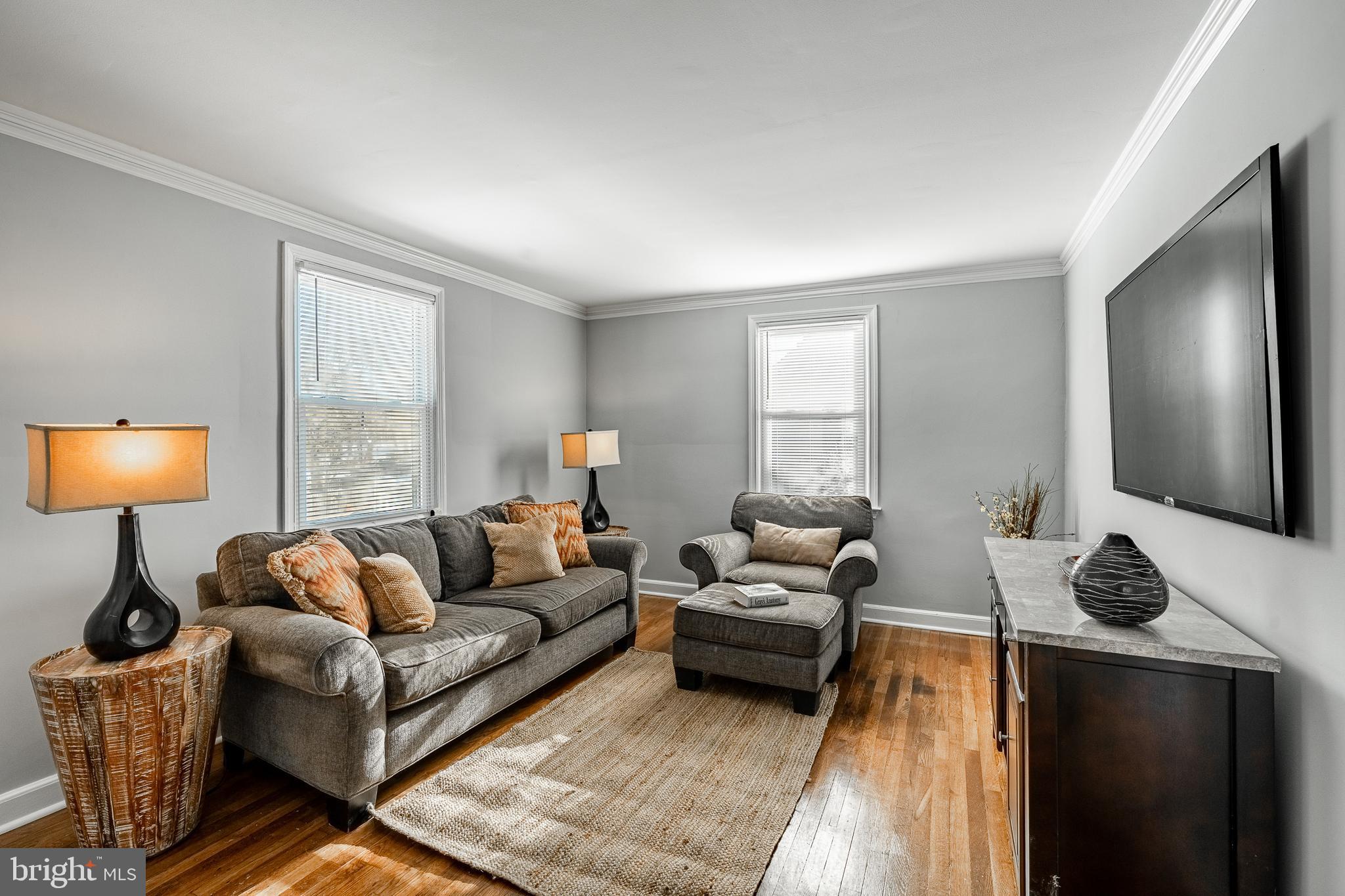 8 Garrett Road Wilmington, DE 19809 - Photo 5 of 37 a living room with furniture and a lamp