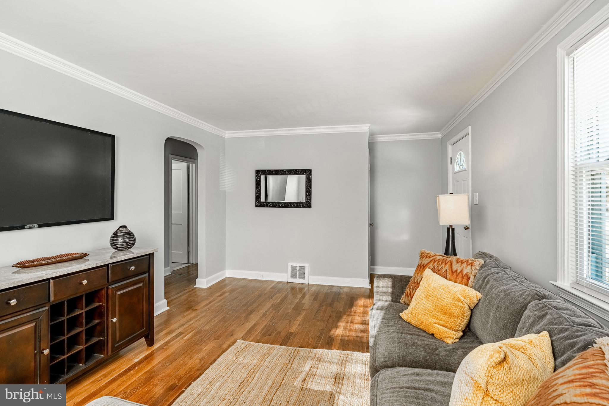 8 Garrett Road Wilmington, DE 19809 - Photo 6 of 37 a living room with a couch and a flat screen tv