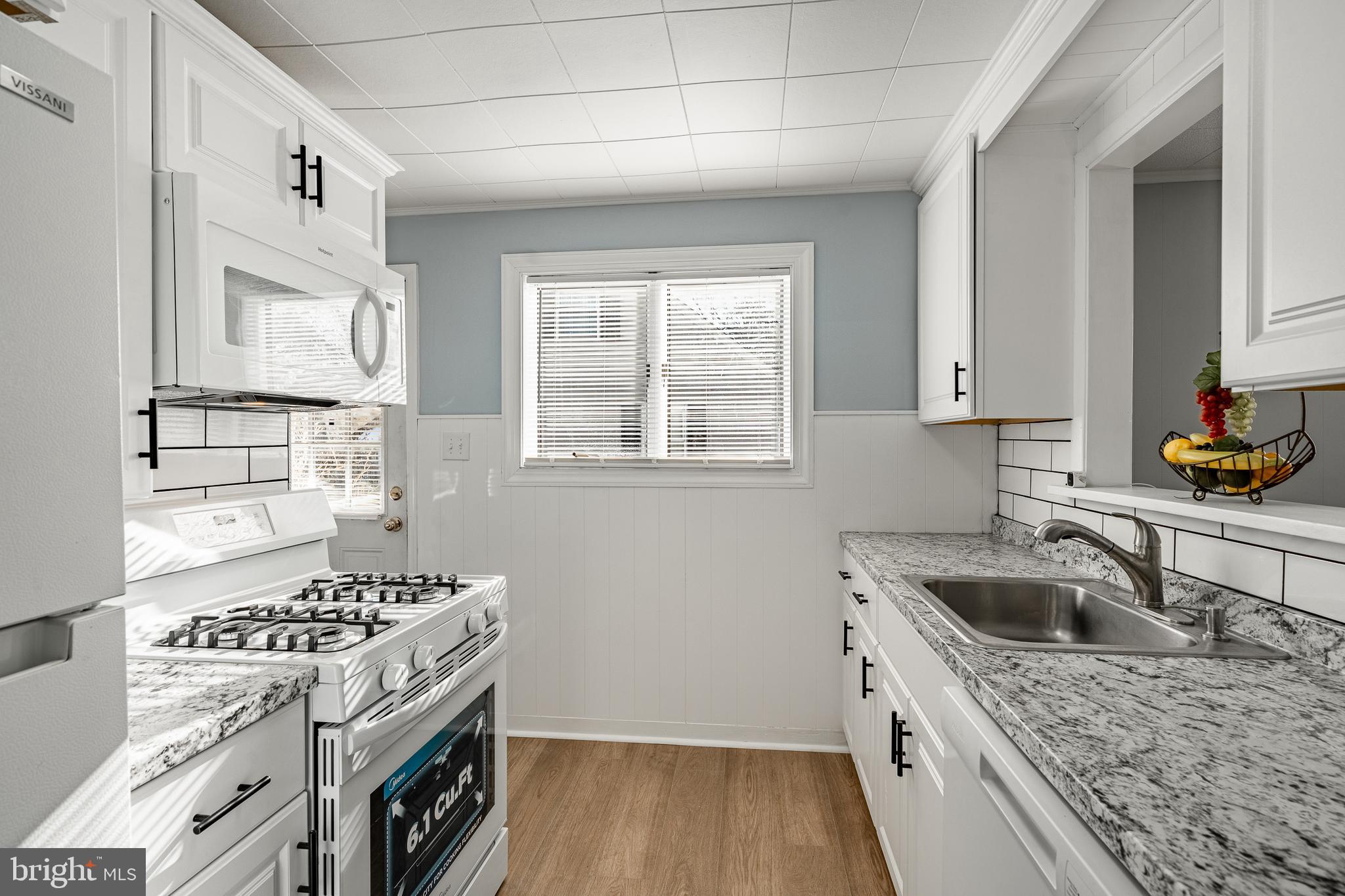 8 Garrett Road Wilmington, DE 19809 - Photo 8 of 37 a kitchen with a stove a sink and a microwave