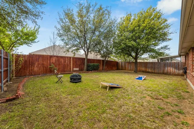 a view of a backyard with table and chairs