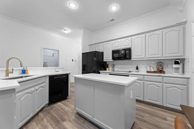 a kitchen with cabinets a sink and appliances