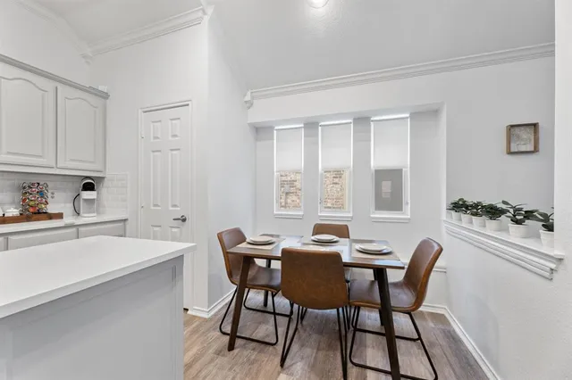 a view of a dining room with furniture and chandelier