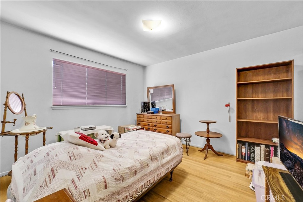 2551 Rome Avenue Anaheim, CA 92804 - Photo 20 of 27 a bedroom with a bed and a book shelf