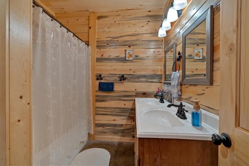 2623 Big Texas Valley Road Northwest Rome, GA 30165 - Photo 27 of 90 a bathroom with a sink and mirror
