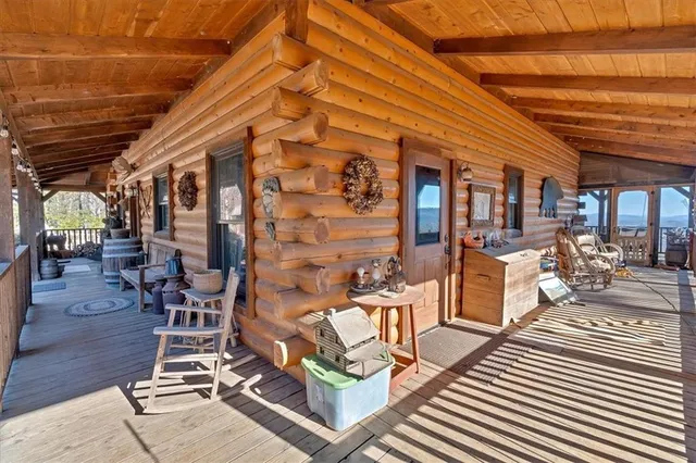 a view of a patio with dining table and chairs with wooden floor
