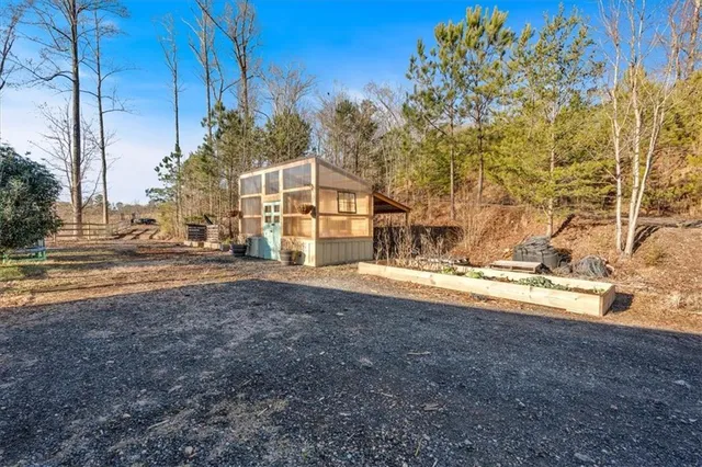 a view of a house with a yard covered in snow