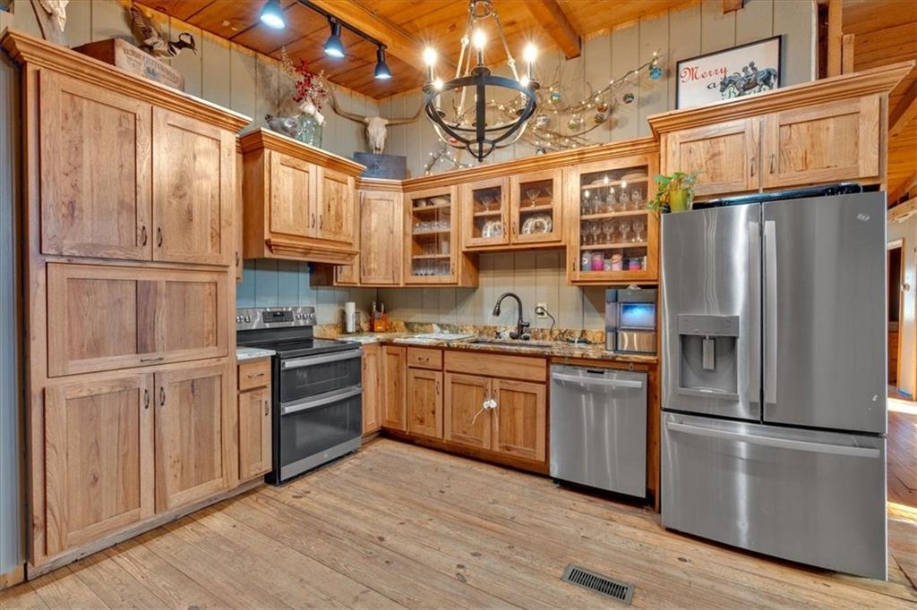 2623 Big Texas Valley Road Northwest Rome, GA 30165 - Photo 35 of 90 a kitchen with stainless steel appliances granite countertop a refrigerator a stove and a sink